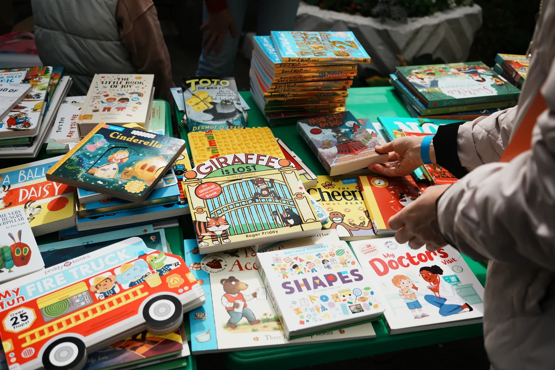 Stacks of English children’s books on a charity-fair table
